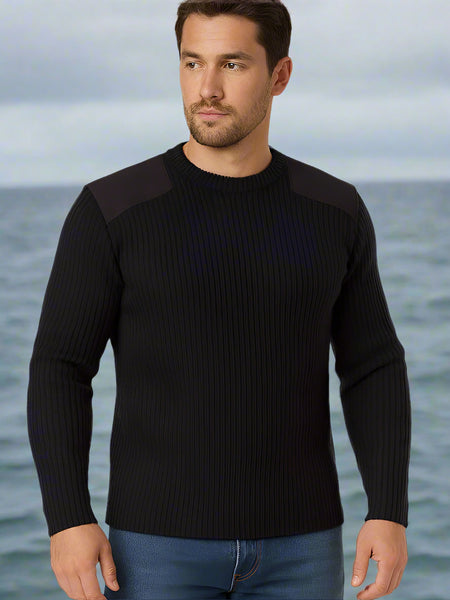 Man wearing a black Commando Sweater with ocean background